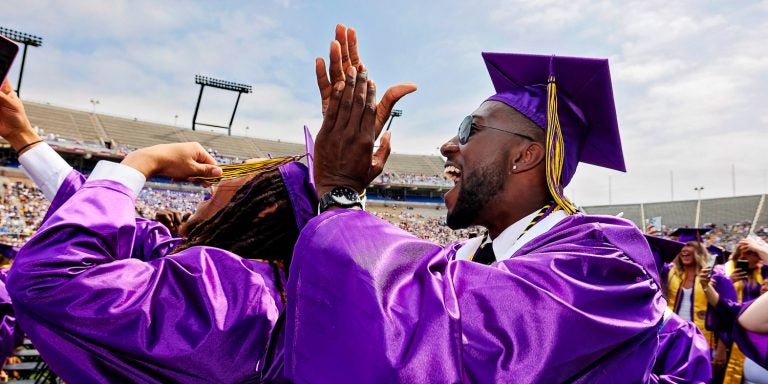 Ravian Jordan, left, and Kayin Fails celebrate at commencement. (ECU Photo by Cliff Hollis)